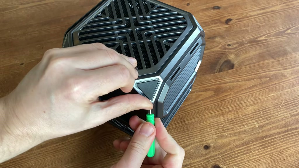 Hidden screw cover being removed from the Tank 03 case